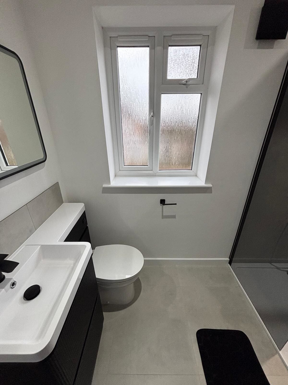 Completed en-suite bathroom installation with shower enclosure in Devizes